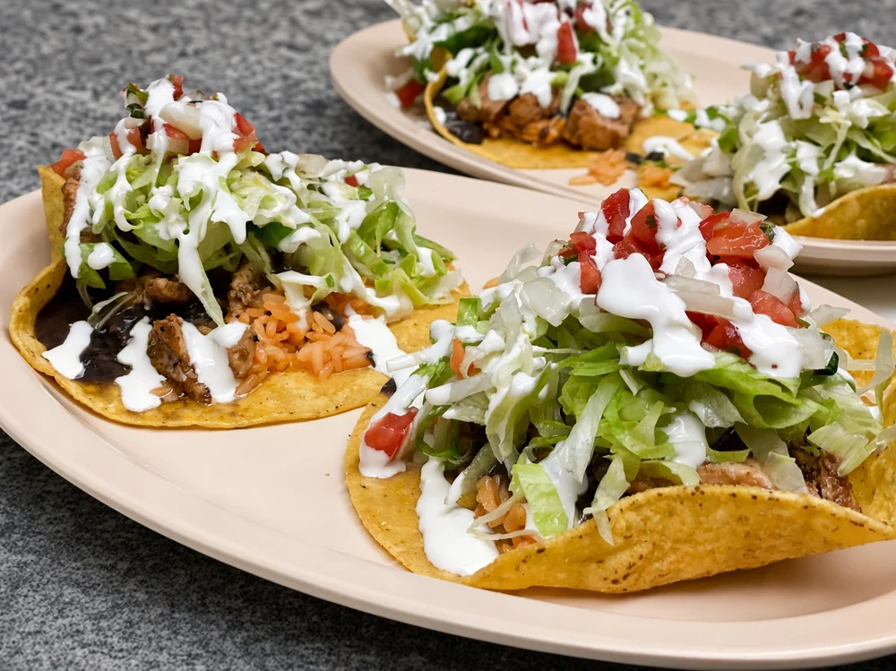 Tostada Duo with lettuce, pico de gallo and sour cream, Mexican food in Winnipeg