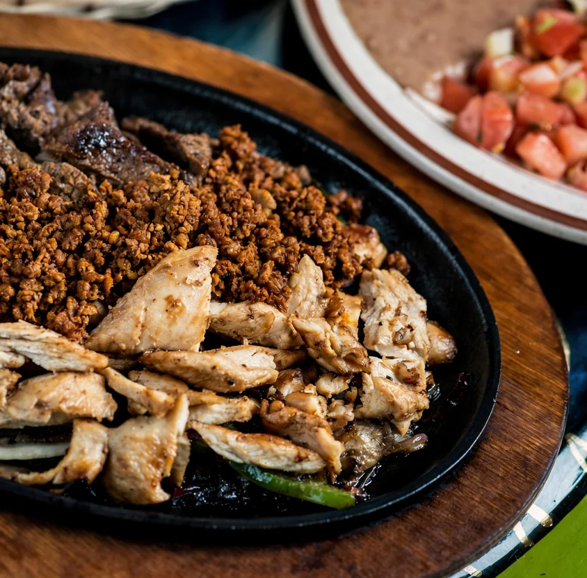 Sizzling parrillada platter with chicken, chorizo and fajita steak at JC's Tacos and More Winnipeg